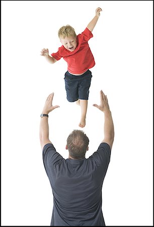 person throwing silhouette - Rear view of a father catching his son Stock Photo - Premium Royalty-Free, Code: 640-01355207
