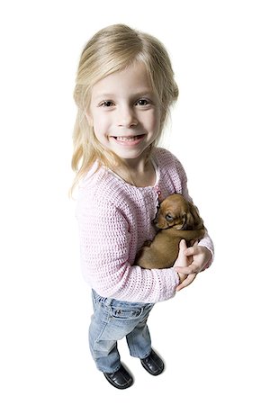 High angle view of a girl holding a dachshund Stock Photo - Premium Royalty-Free, Code: 640-01355200