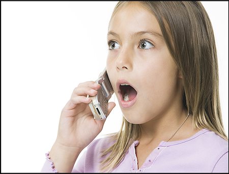 shocked tween girls - Close-up of a girl talking on a cell phone Stock Photo - Premium Royalty-Free, Code: 640-01355202