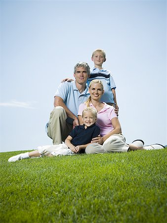simsearch:632-02744729,k - Low angle view of a family sitting on grass Stock Photo - Premium Royalty-Free, Code: 640-01355228