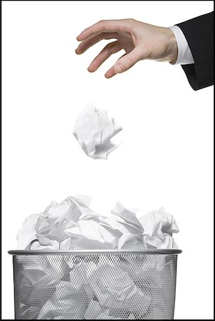 fuller - Close-up of a businessman's hand throwing a paper ball into a garbage bin Stock Photo - Premium Royalty-Free, Code: 640-01355353