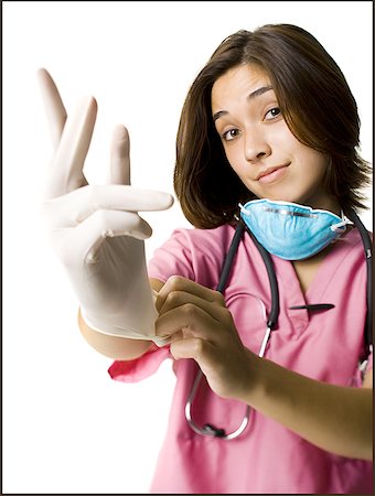 female doctor gloves mask scrub - Female doctor in pink scrubs with rubber glove Stock Photo - Premium Royalty-Free, Code: 640-01355373
