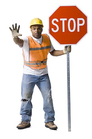 Road worker with stop sign and hardhat Stock Photo - Premium Royalty-Free, Code: 640-01355420