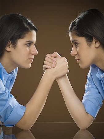 simsearch:400-05734883,k - Profile of two teenage girls arm wrestling Stock Photo - Premium Royalty-Free, Code: 640-01355456