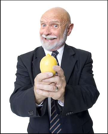 simsearch:640-01366339,k - Portrait of a businessman holding a lemon Foto de stock - Royalty Free Premium, Número: 640-01355548