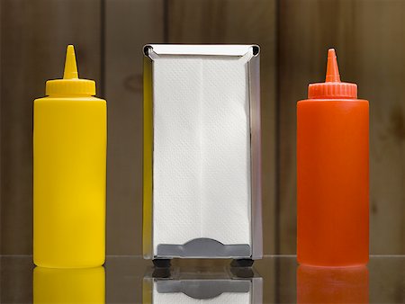 fast food restaurant inside - Ketchup mustard and napkin dispenser Stock Photo - Premium Royalty-Free, Code: 640-01355573