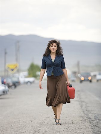 roadside assistance - A young woman walking with a gas can Stock Photo - Premium Royalty-Free, Code: 640-01355610