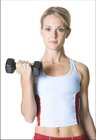 simsearch:640-01355937,k - Portrait of a young woman picking up a dumbbell Foto de stock - Sin royalties Premium, Código: 640-01355677