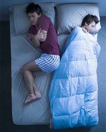 simsearch:640-01355958,k - Woman in bed asleep with blanket and man sleeping curled up and cold Stock Photo - Premium Royalty-Free, Code: 640-01355958