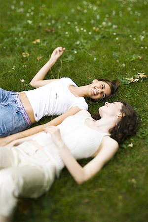 High angle view of two teenage girls lying on the grass Stock Photo - Premium Royalty-Free, Code: 640-01356018