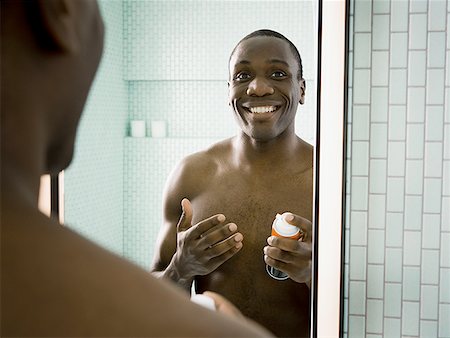 Close-up of a man holding a can of shaving cream Stock Photo - Premium Royalty-Free, Code: 640-01356012