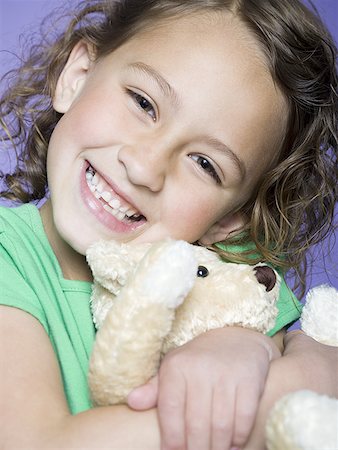 Portrait of a girl hugging a teddy bear Stock Photo - Premium Royalty-Free, Code: 640-01356168