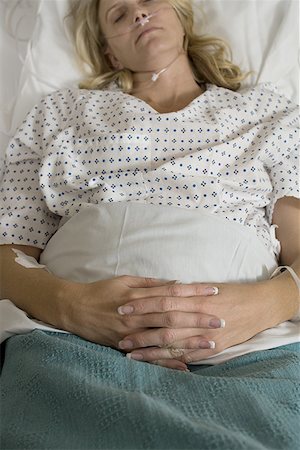 person in hospital bed overhead - High angle view of a female patient sleeping Stock Photo - Premium Royalty-Free, Code: 640-01356196