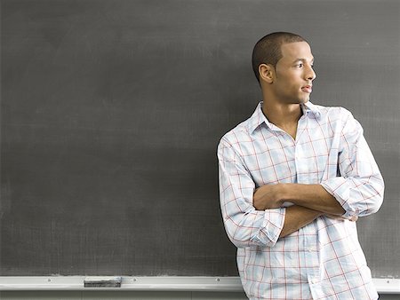 simsearch:640-01365323,k - African American male student leaning against chalkboard Fotografie stock - Premium Royalty-Free, Codice: 640-01356262