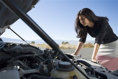 skirt bend - Woman looking inside a car engine Stock Photo - Premium Royalty-Free, Code: 640-01356439