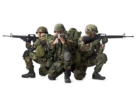 Three soldiers crouching and aiming their rifles Stock Photo - Premium Royalty-Free, Code: 640-01356440