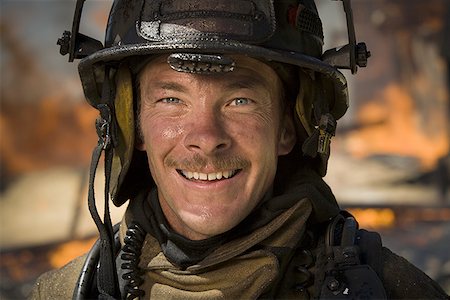 shadow hero - Close-up of a firefighter smiling Stock Photo - Premium Royalty-Free, Code: 640-01356473
