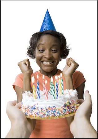 Close-up of a young woman looking at a birthday cake Stock Photo - Premium Royalty-Free, Code: 640-01356539