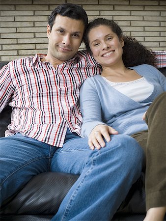 simsearch:640-01356582,k - Portrait of a couple sitting on a couch and smiling Stock Photo - Premium Royalty-Free, Code: 640-01356582