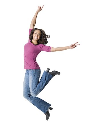 simsearch:640-01358649,k - Portrait of a young woman jumping with her arms raised Fotografie stock - Premium Royalty-Free, Codice: 640-01356659