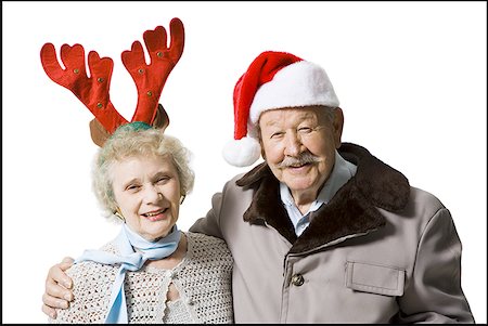 senior couple eye contact head and shoulders not indoors - Older couple wearing Christmas hats Stock Photo - Premium Royalty-Free, Code: 640-01356827