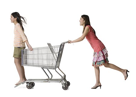 small store - Profile of a young woman pushing a teenage girl in a shopping cart Stock Photo - Premium Royalty-Free, Code: 640-01356884