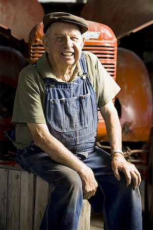 Farmer posing with his tractor Stock Photo - Premium Royalty-Free, Code: 640-01356899