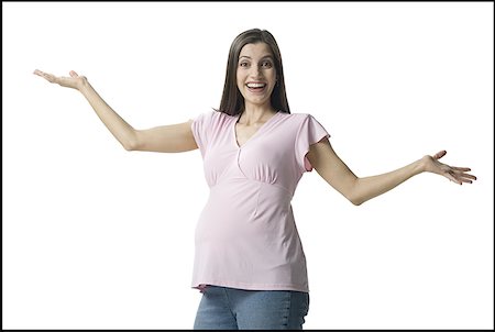 pregnant woman standing white background - Portrait of a pregnant woman smiling Stock Photo - Premium Royalty-Free, Code: 640-01356918