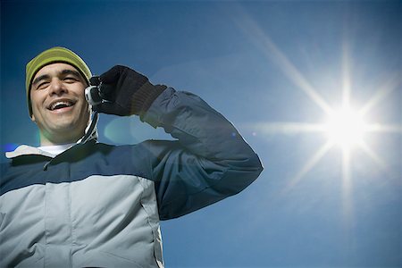 simsearch:640-01354485,k - Low angle view of a young man talking on a mobile phone Stock Photo - Premium Royalty-Free, Code: 640-01356938