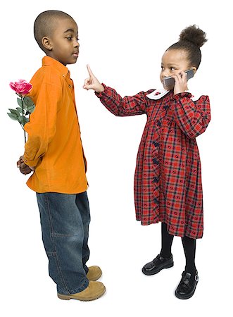 simsearch:695-03388823,k - Profile of a boy looking at a girl talking on a mobile phone Stock Photo - Premium Royalty-Free, Code: 640-01356947