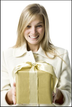 excited women holding money - Close-up of a young woman looking at a gift Stock Photo - Premium Royalty-Free, Code: 640-01356955