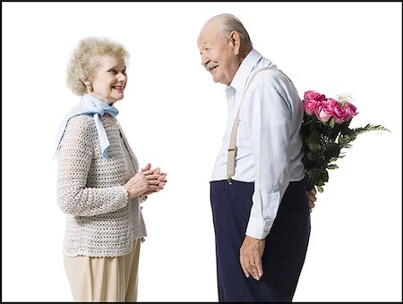 pink, rose, white background - Older man with bouquet of pink roses behind back Stock Photo - Premium Royalty-Free, Code: 640-01356997