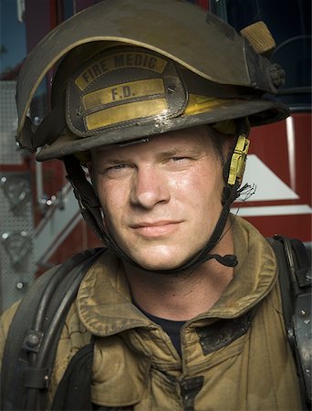 firefighter close - Portrait of a firefighter wearing a helmet Stock Photo - Premium Royalty-Free, Code: 640-01357009
