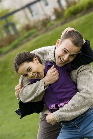 Portrait of a father with his daughter in a park Stock Photo - Premium Royalty-Free, Code: 640-01357027