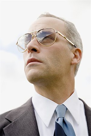 sunglasses for bald men - Close-up of a businessman looking up Stock Photo - Premium Royalty-Free, Code: 640-01357033
