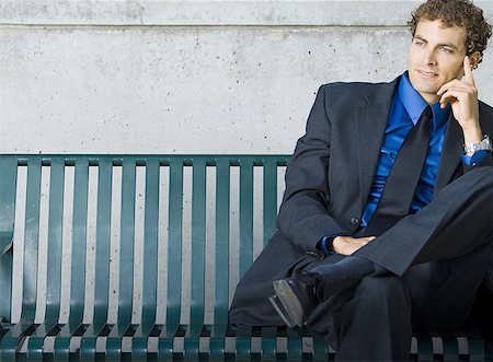 Businessman sitting on a bench Stock Photo - Premium Royalty-Free, Code: 640-01357284