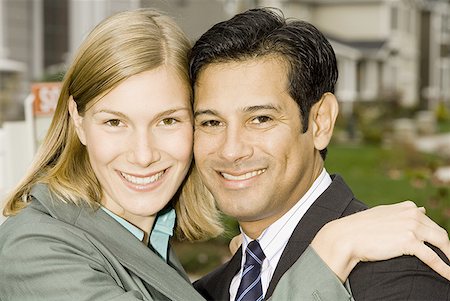 Portrait of a businessman and a businesswoman smiling Stock Photo - Premium Royalty-Free, Code: 640-01357289