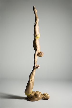 simsearch:640-01350572,k - Profile of two male acrobats performing Stock Photo - Premium Royalty-Free, Code: 640-01357307