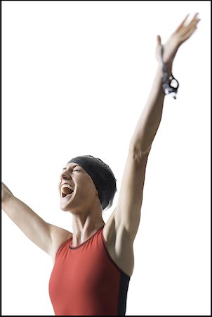 simsearch:640-01365316,k - Low angle view of a young woman smiling with her arms raised Fotografie stock - Premium Royalty-Free, Codice: 640-01357326