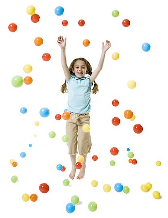 A girl smiling and playing with colored balls Stock Photo - Premium Royalty-Free, Code: 640-01357320