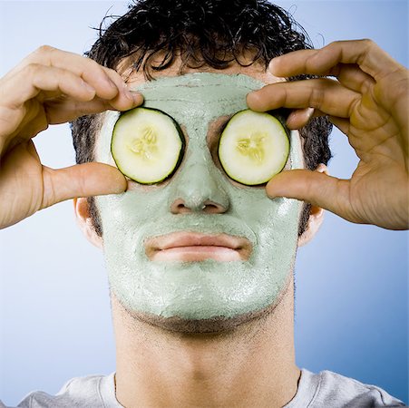 Man with mud mask and cucumber slices on eyes Stock Photo - Premium Royalty-Free, Code: 640-01357389