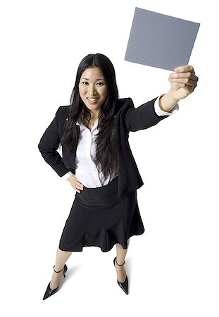 simsearch:640-01355807,k - Businesswoman holding a blank sign Foto de stock - Sin royalties Premium, Código: 640-01357478