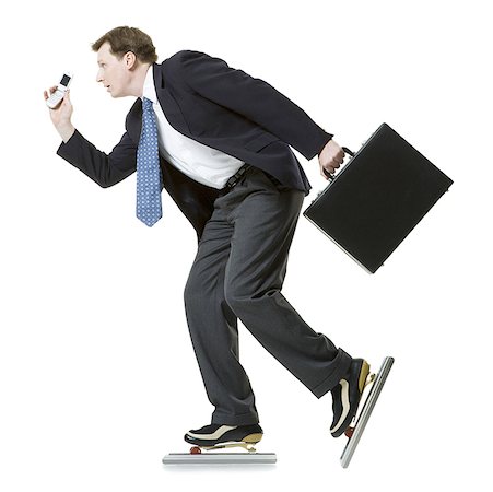 Profile of a businessman ice- skating Stock Photo - Premium Royalty-Free, Code: 640-01357481