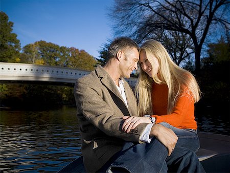 sitting on lap facing each other - Couple embracing while sitting on a boat Stock Photo - Premium Royalty-Free, Code: 640-01357504