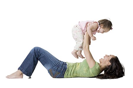 Profile of a woman holding up her daughter Stock Photo - Premium Royalty-Free, Code: 640-01357503