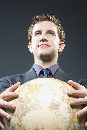 simsearch:640-02951526,k - Low angle view of a businessman holding a globe Foto de stock - Sin royalties Premium, Código: 640-01357599