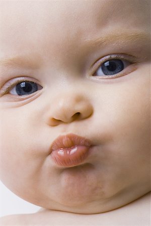 funny cartoon face - Close-up of a baby girl puckering her lips Stock Photo - Premium Royalty-Free, Code: 640-01357609