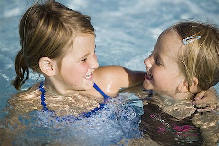 simsearch:640-02769656,k - Two girls in swimming pool Foto de stock - Sin royalties Premium, Código: 640-01357633