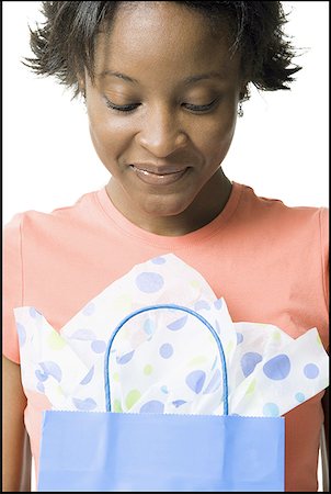 Close-up of a young woman holding a shopping bag Stock Photo - Premium Royalty-Free, Code: 640-01357777