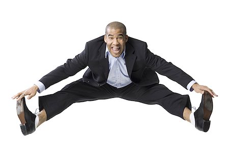 simsearch:640-01362252,k - Portrait of a businessman smiling and jumping Foto de stock - Royalty Free Premium, Número: 640-01357901
